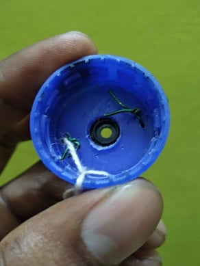Servo motor shaft connected to bottle cap using copper wires- internal