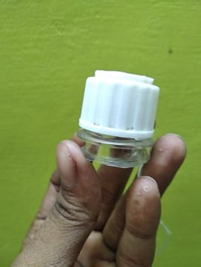 bottle neck with a hole drilled on its cap