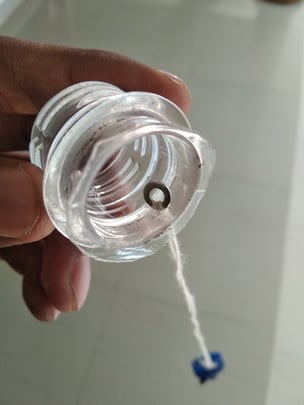 loop thread attached to cap using the metal washer
