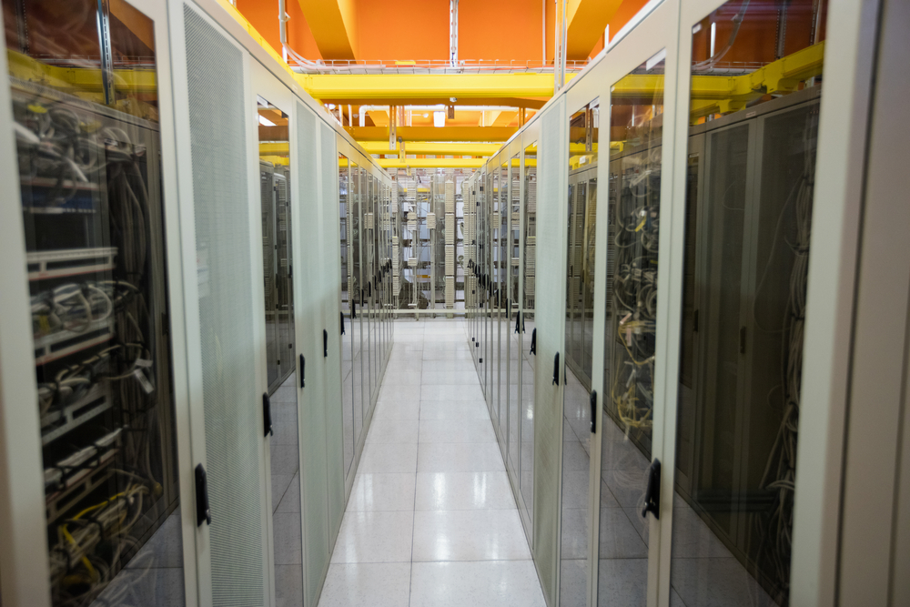 Hallway with a row of servers in server room
